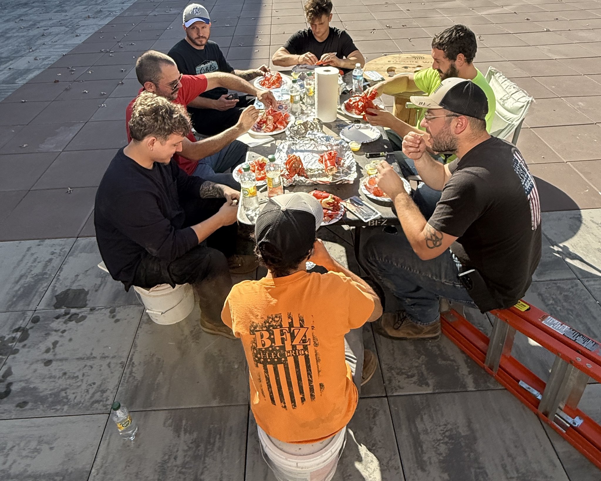 BFZ Electric crew sharing a lobster lunch on a rooftop
