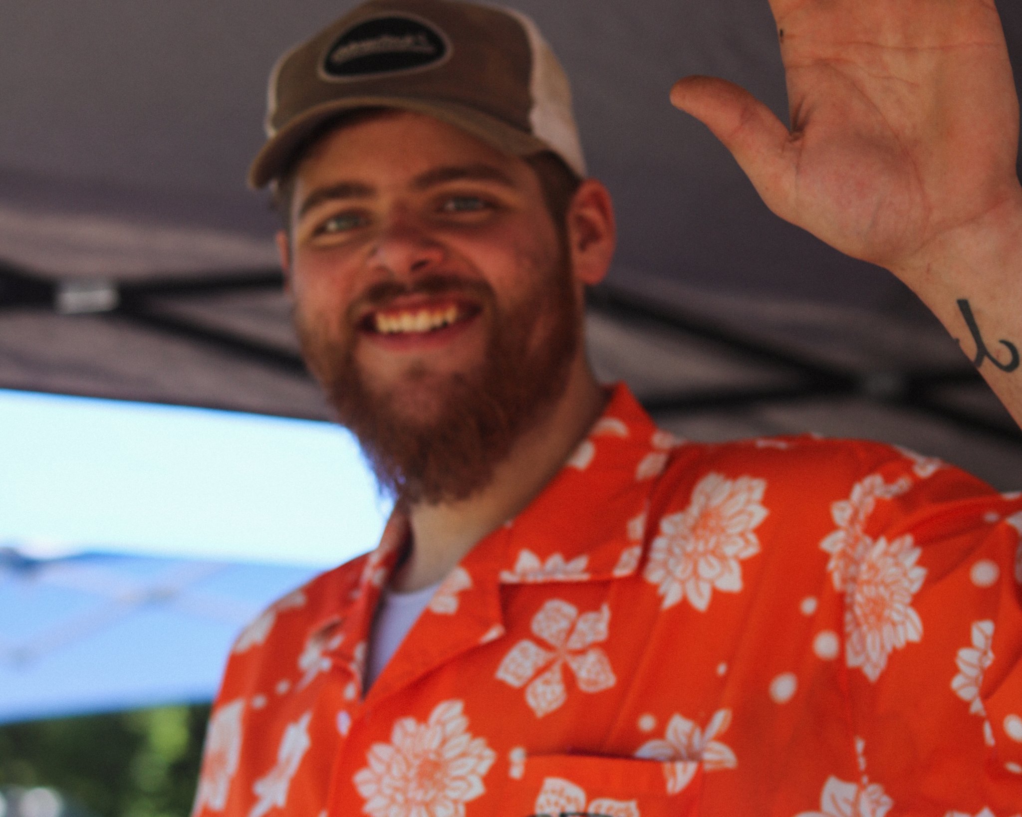 BFZ Electric team member waving in an orange BFZ shirt
